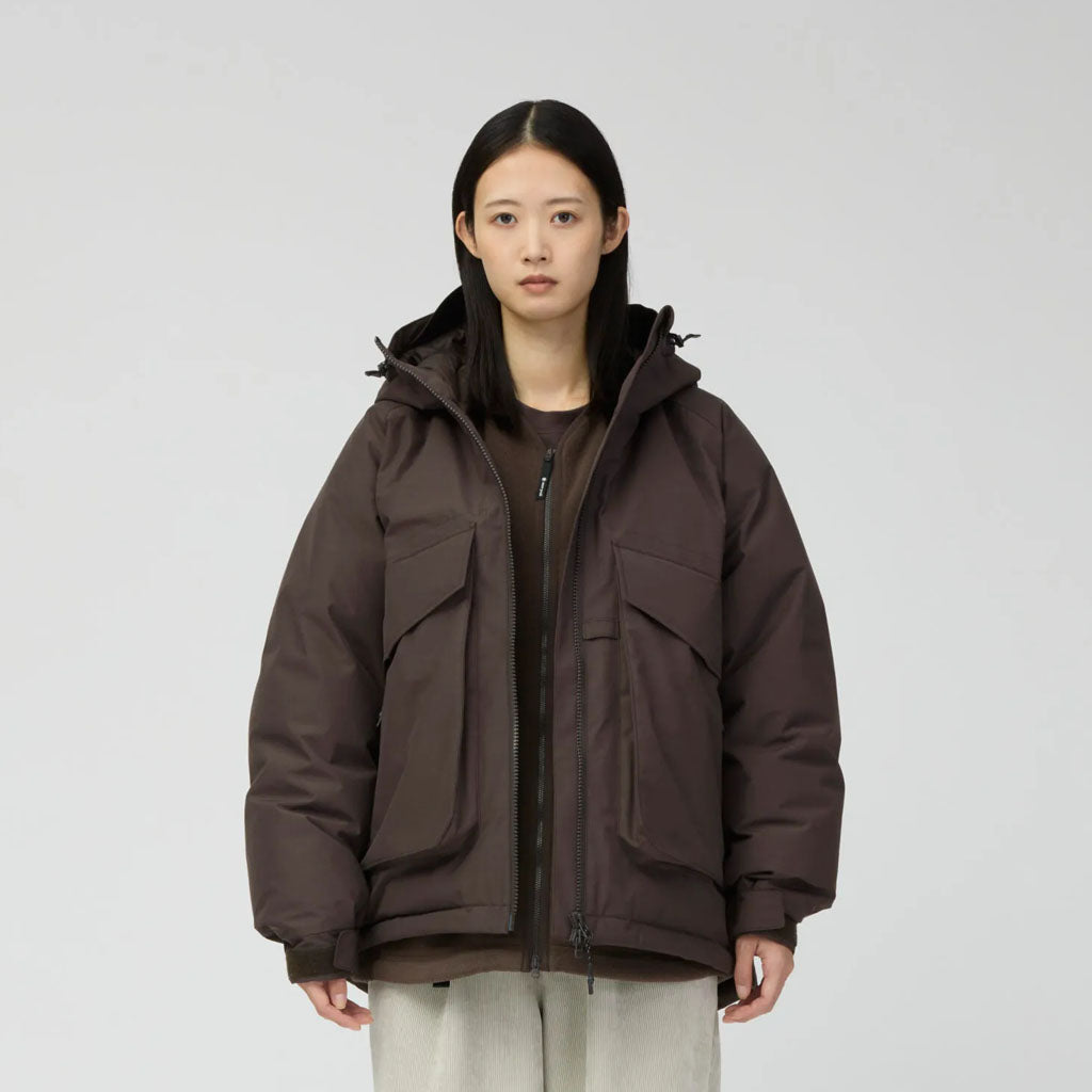 Snow Peak women's brown puffer jacket with hood and cargo pockets on neutral background