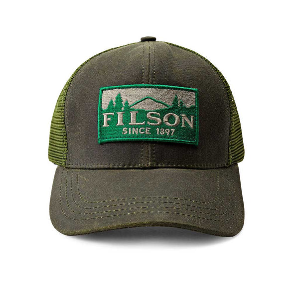 A green Filson mesh logger cap with an adjustable strap and a brass buckle, featuring the Filson logo on the front.