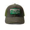 A green Filson mesh logger cap with an adjustable strap and a brass buckle, featuring the Filson logo on the front.