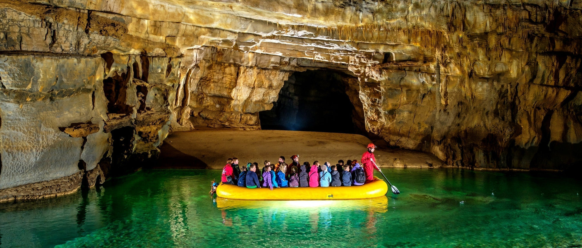 Exploring the subterranean lakes of Križna jama, Cross Cave, in Slovenia. Photo by Peter Gedei.